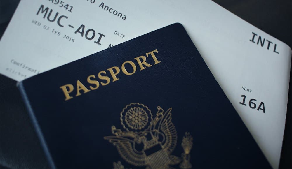 Passport resting on travel paperwork